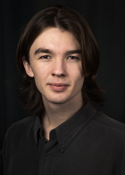 Example of a non-smiling headshot. Hugh has a tiny smile in the corners of his mouth which keep his headshot from being too serious. His lips are relaxed in order to keep tension out of his face. He is also turned at a 45 degree angle which is very flattering. His jawline is accentuated as he pushes his chin out and down. Hugh has a very slight frown to add gravitas to the headshot.