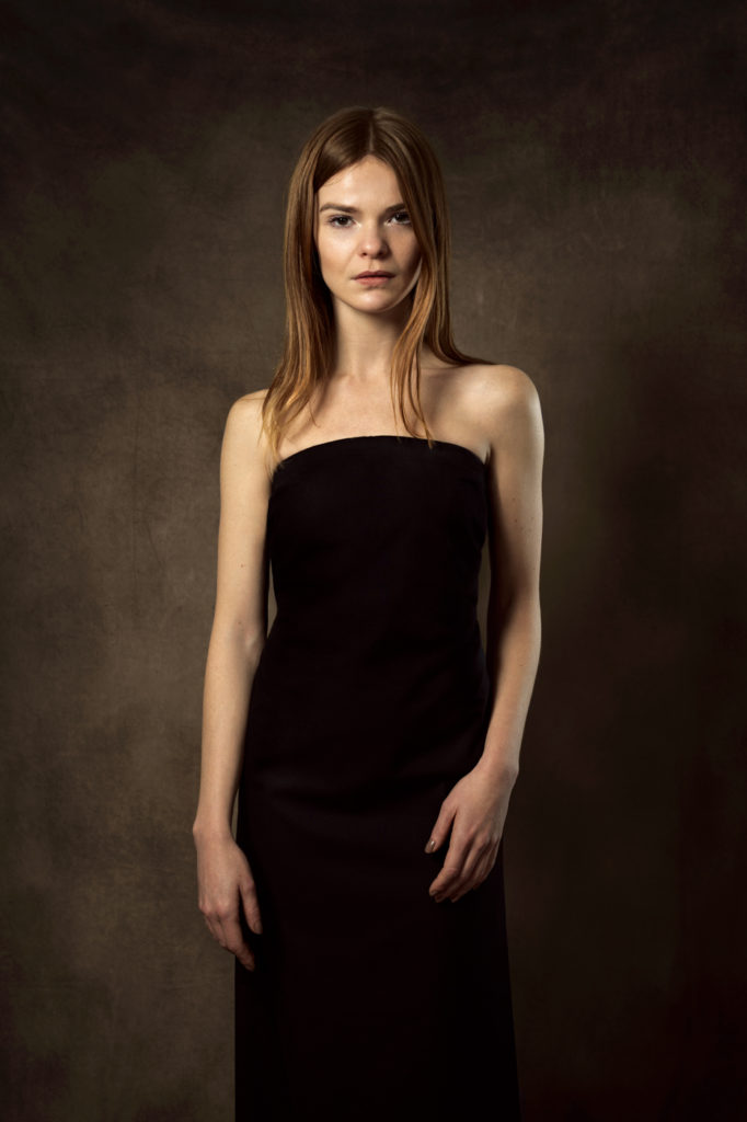A simple, fitted black bandeau dress suits most women.